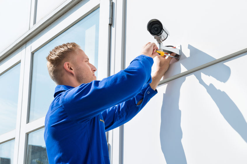 technician installing security camera